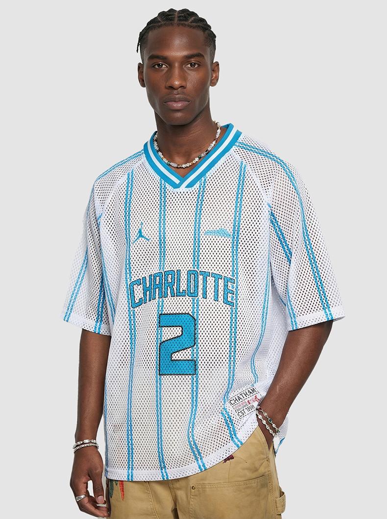 White mesh Charlotte jersey T-shirt with blue stripes and number 2 on a model, streetwear style