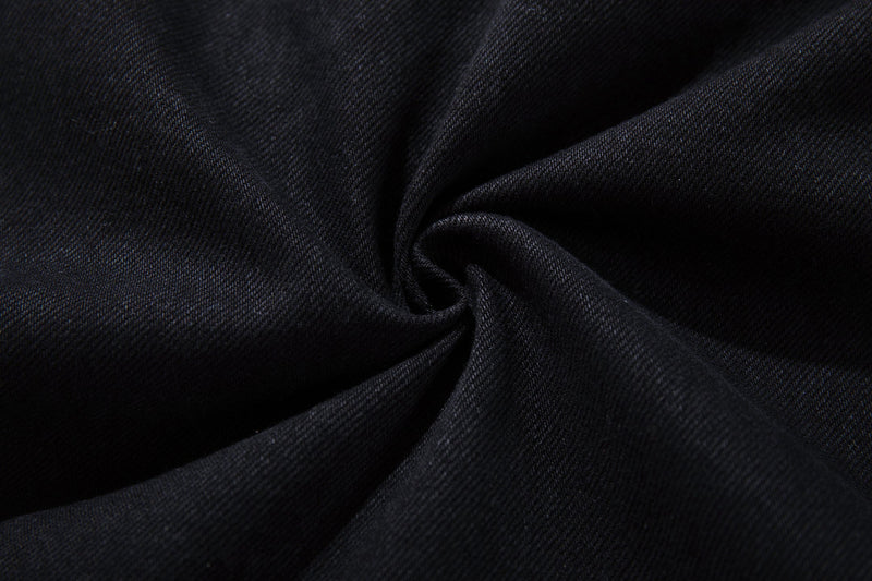 Close-up of black denim fabric texture with soft folds