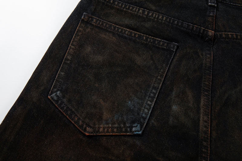 Close-up of the left back pocket on dark washed denim jeans