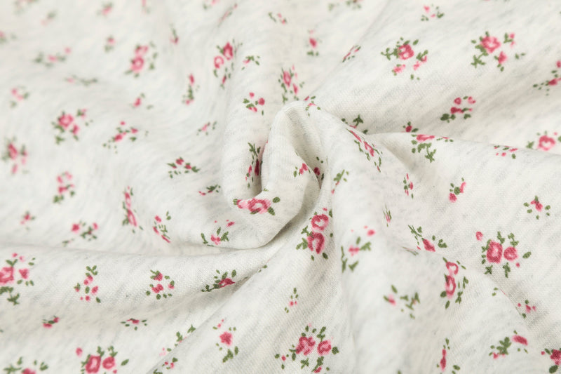 Close-up of gathered floral fabric on cream balaclava hoodie