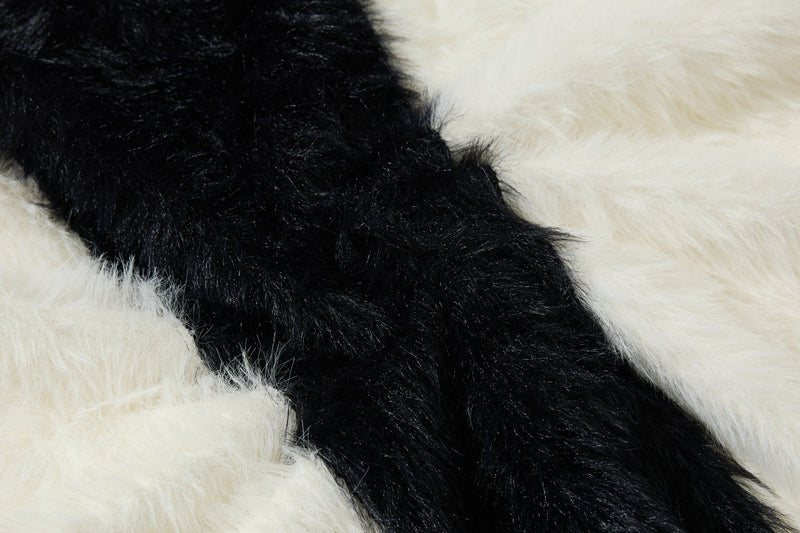 Close-up of black and white fuzzy fabric with diagonal cross stripe