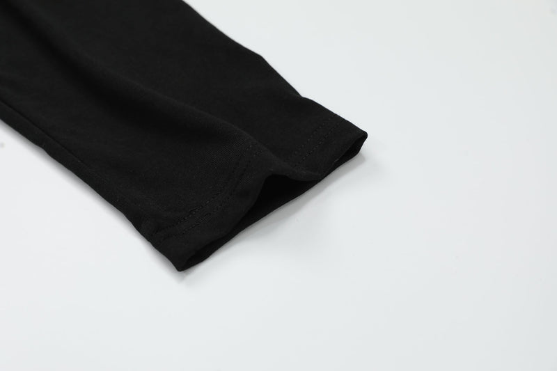 Black sleeve cuff detail with stitched hem on long sleeve top