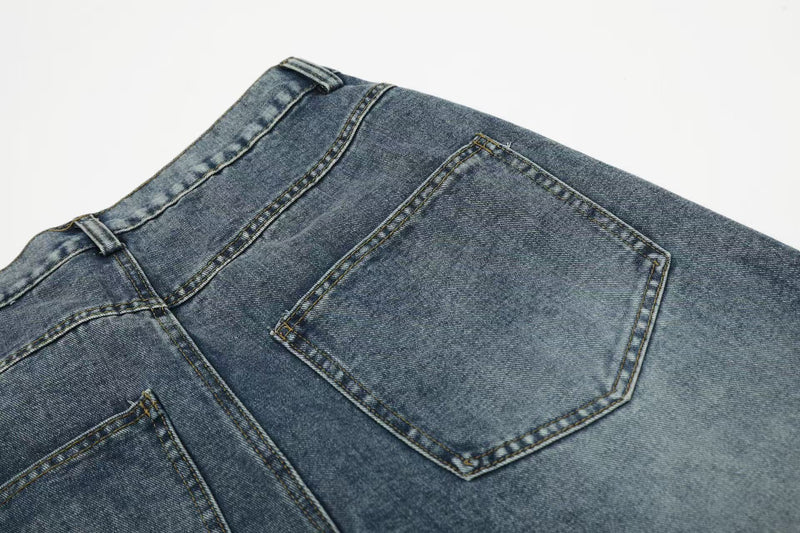 Close-up of back patch pocket on faded blue denim jeans