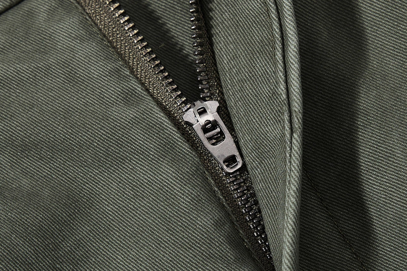 Close-up of olive green zipper fly on wide-leg pants