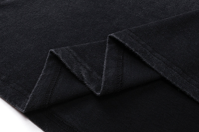 Close-up of black tee hem with folded stitching detail