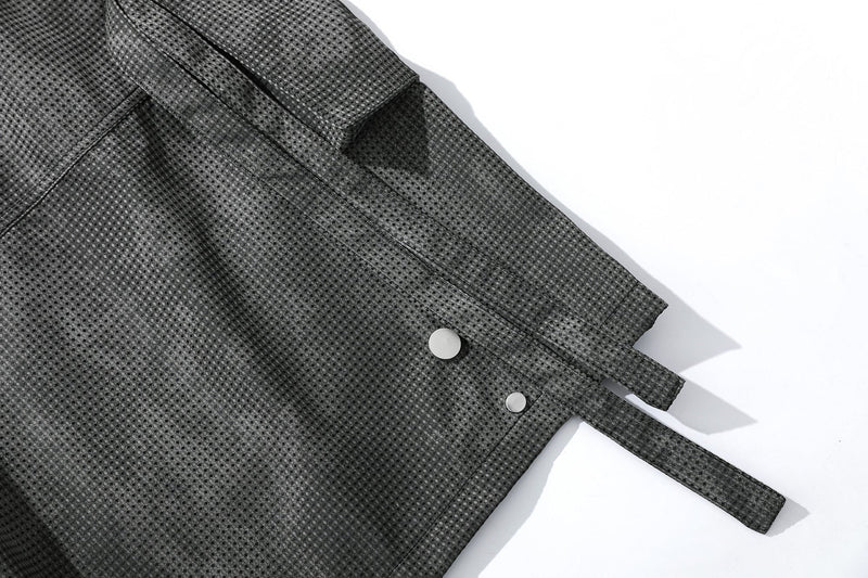 Close-up of black mesh shorts side seam with snap button and hanging strap