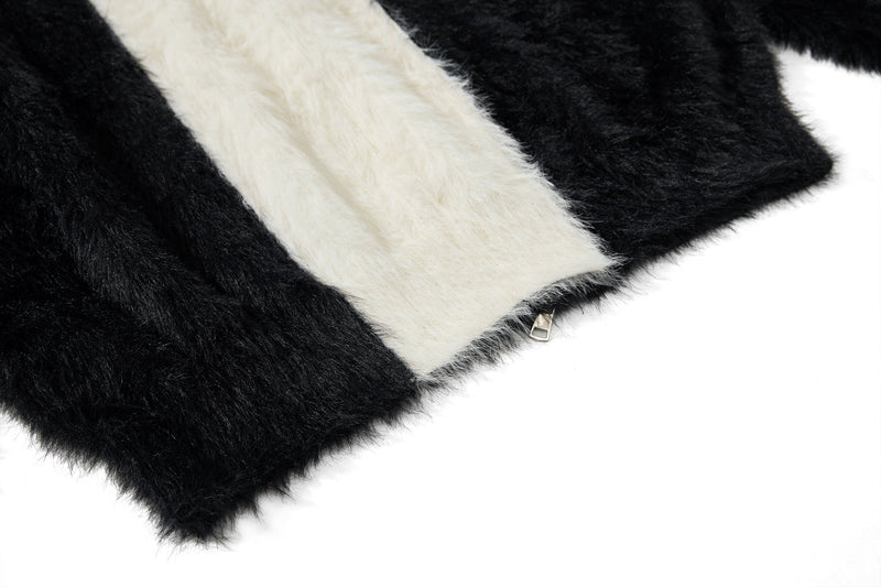 Close-up of black and white fuzzy sleeve with zipper detail