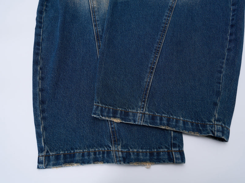 Close-up of the lower legs and hems on faded wide-leg blue jeans
