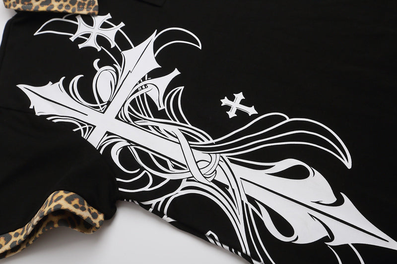 Black polo shirt with bold white gothic cross graphic and leopard-print collar trim on a Y2K streetwear design