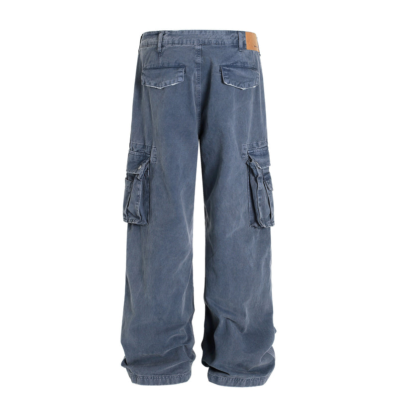 Back view of washed blue wide-leg cargo pants with flap pockets and tan waistband patch