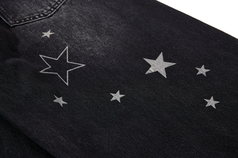 Close-up of black star-washed denim with front pocket edge