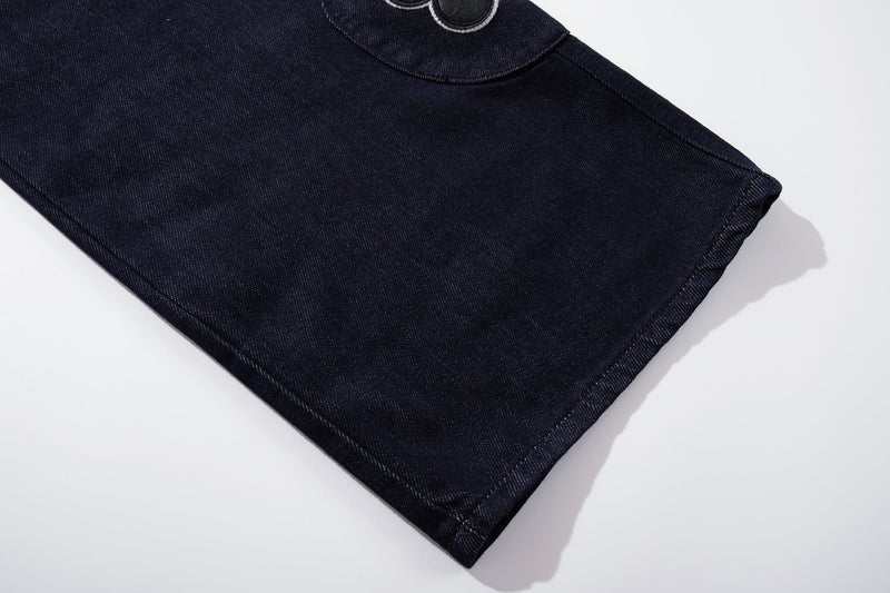 Wide-leg dark wash jeans hem, angled close-up view