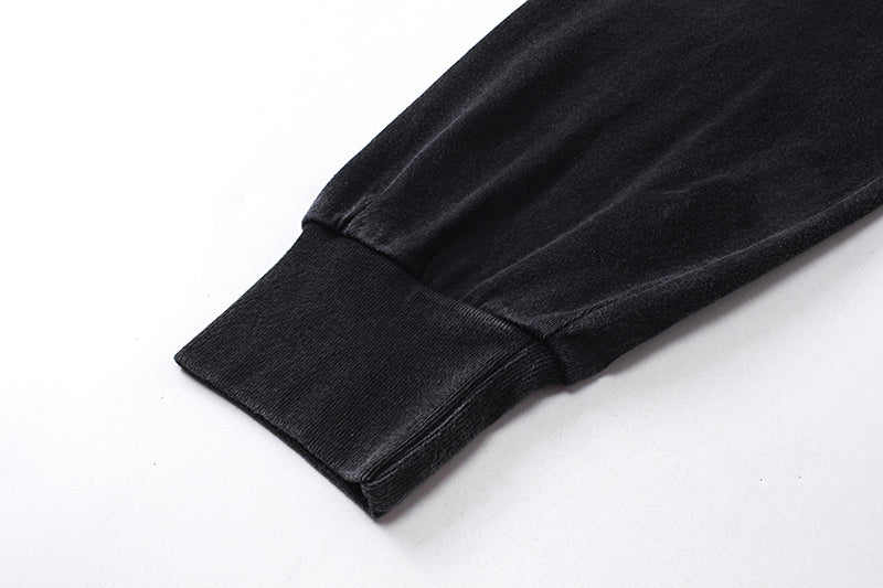 Close-up of black long sleeve tee sleeve cuff with ribbed wrist detail