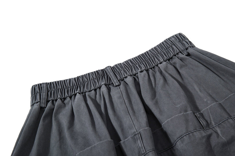 Close-up of dark gray elastic waistband with gathered back panel
