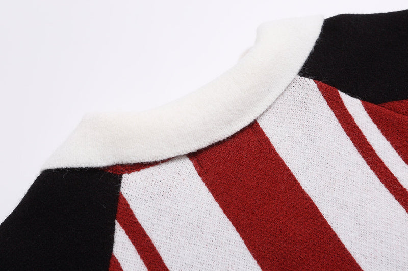 Close-up of white collar and black shoulder on red and white striped knit sweater