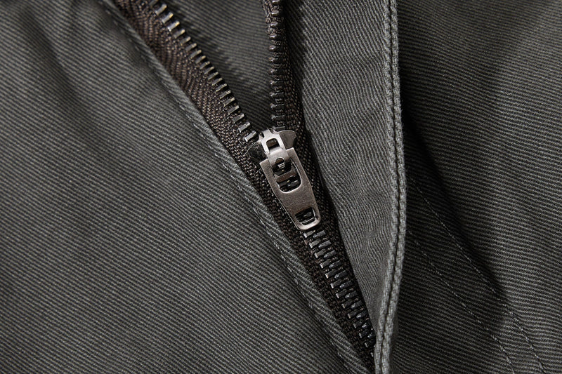 Close-up of black zipper fly and front seam detail