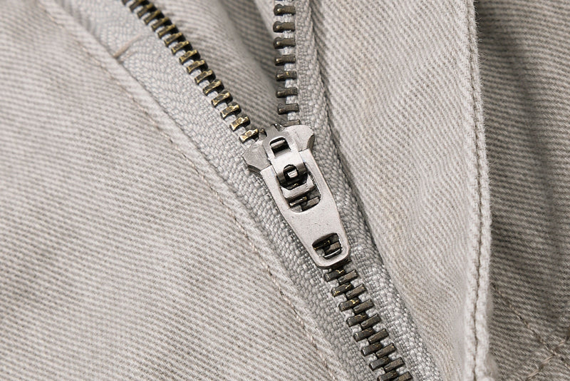 Close-up of beige zipper fly on utility pants