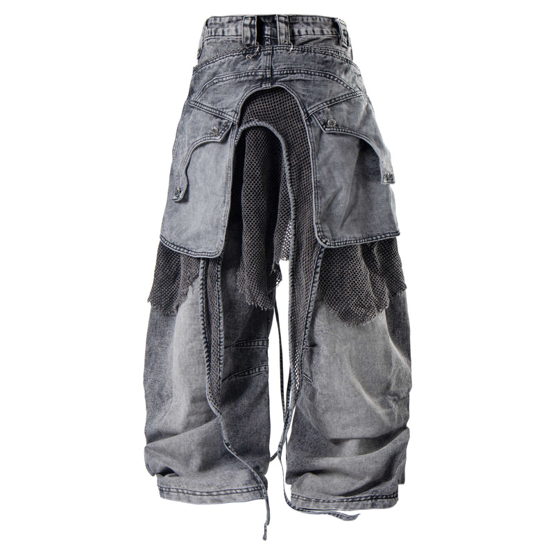 Front view of gray cargo mesh distressed denim jeans with layered flap pockets