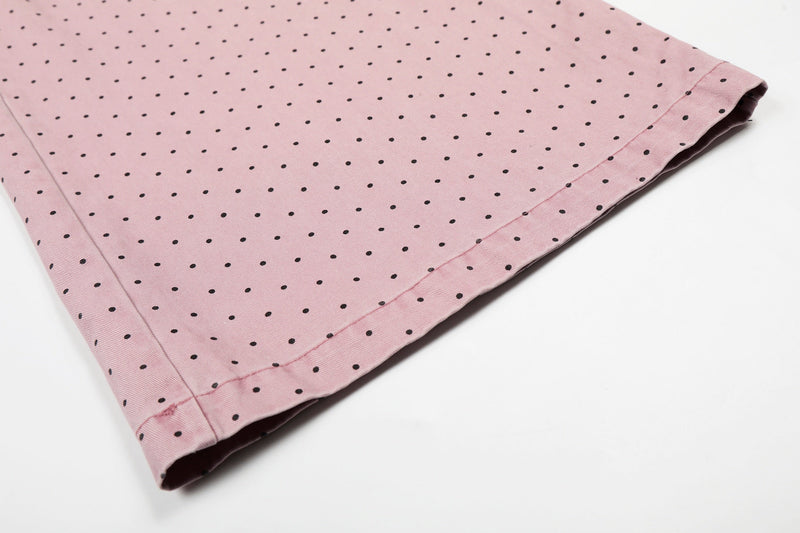 Close-up of wide pant leg hem on pink polka dot pants