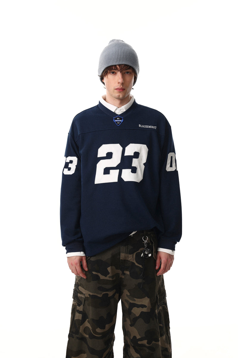 Navy long sleeve tee worn over a white collar with white number 23 graphic, front view