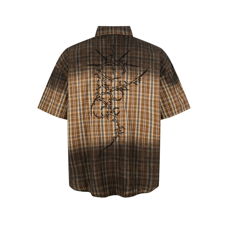 Brown plaid short-sleeve shirt with black graphic artwork on the back, styled in a vintage retro streetwear look