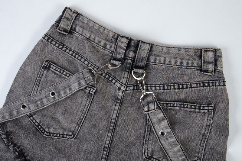 Upper back detail of washed black cargo jeans with belt loops and diagonal strap