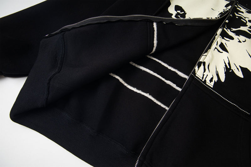 Inside view of black hoodie with white graphic lining and zip edge