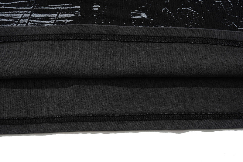 Vintage washed black graphic tee with visible raw hems and distressed fabric texture