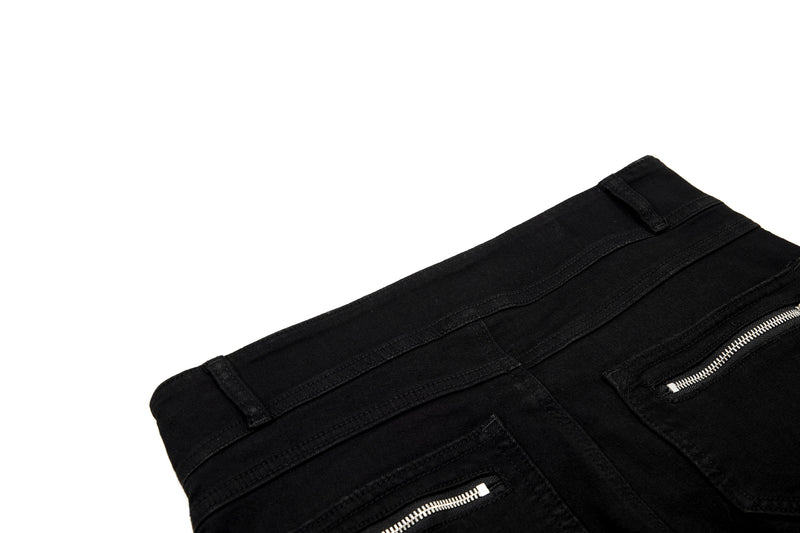 Close-up of back waistband and zippered pocket on black pants