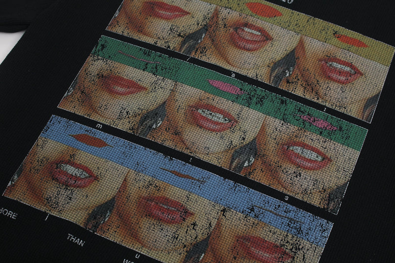 Black streetwear tee with collage-style pop art lips and face graphics in layered color blocks