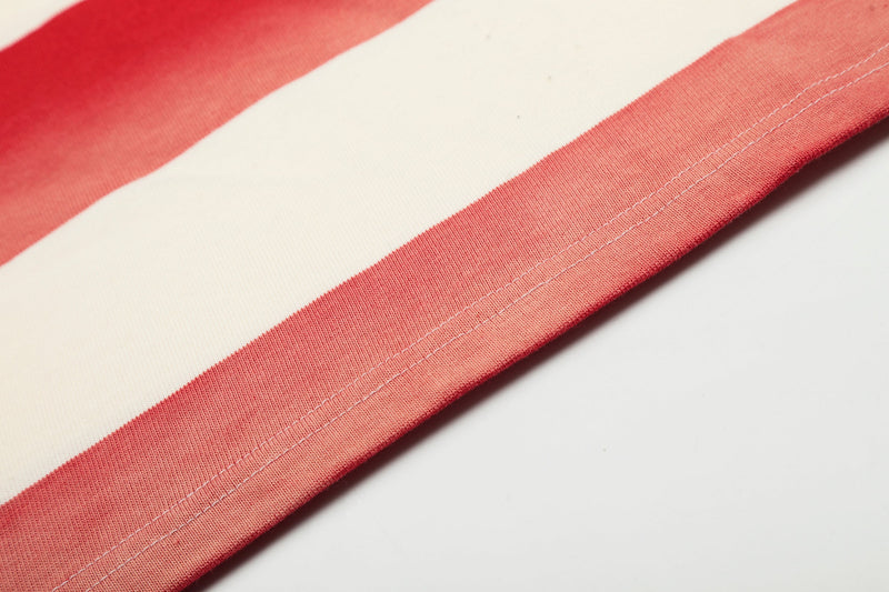 Close-up of striped shirt hem seam on cream and red rugby polo shirt