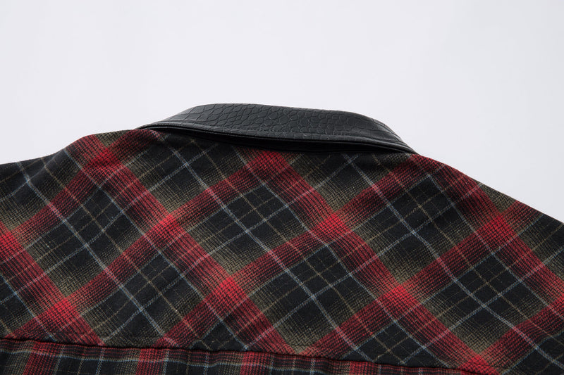 Close-up of the faux-leather collar on a red and black plaid flannel shirt jacket