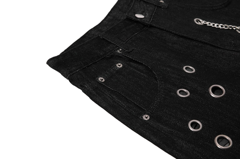 Close-up of black denim side panel with eyelets and chain detail