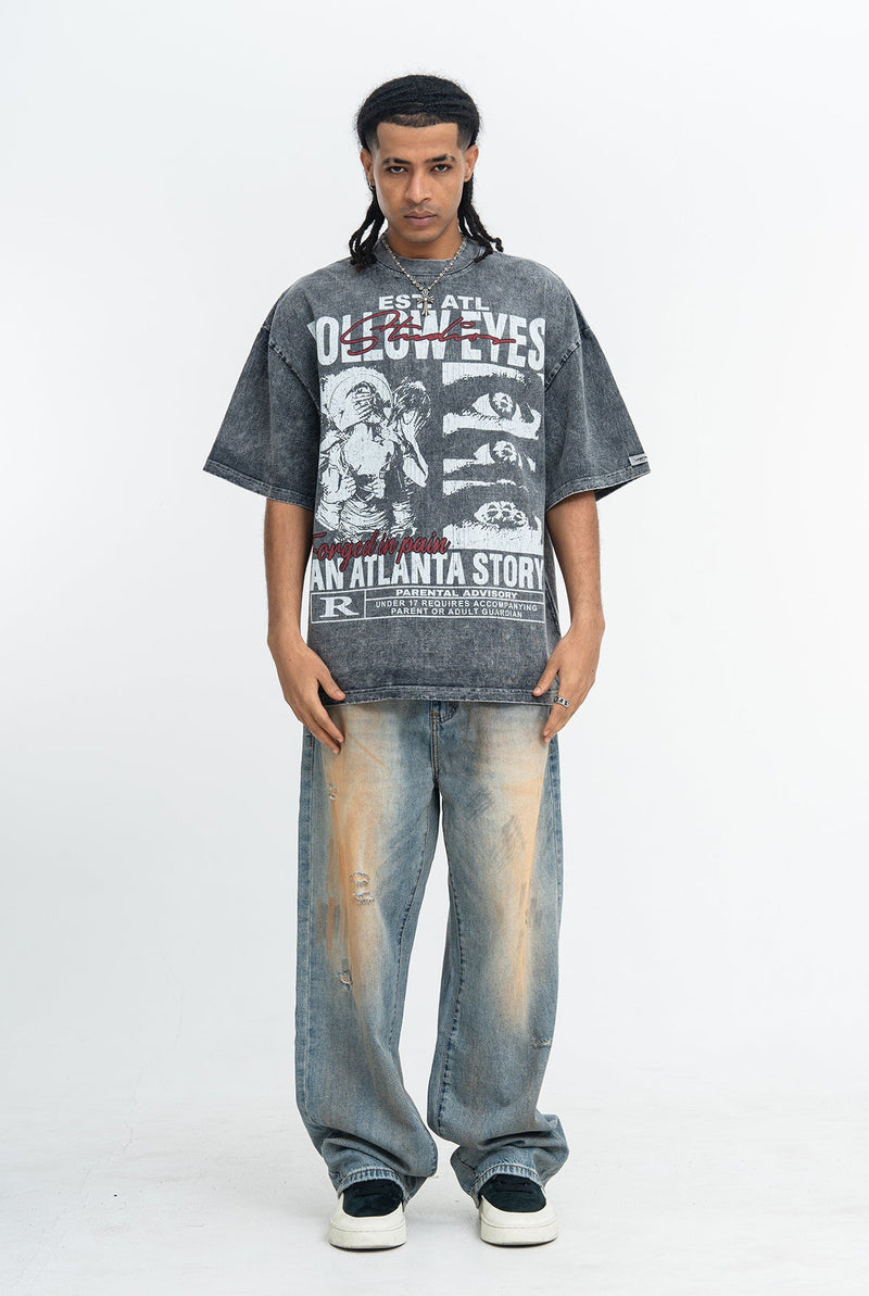 Model wearing a vintage washed oversized graphic tee with Atlanta story print, paired with faded baggy jeans and sneakers