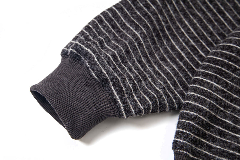 Close-up of striped knit sleeve cuff with ribbed ribbed black cuff