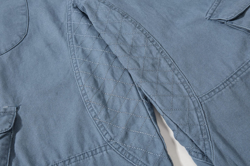 Close-up of blue cargo pants quilted inner leg panel
