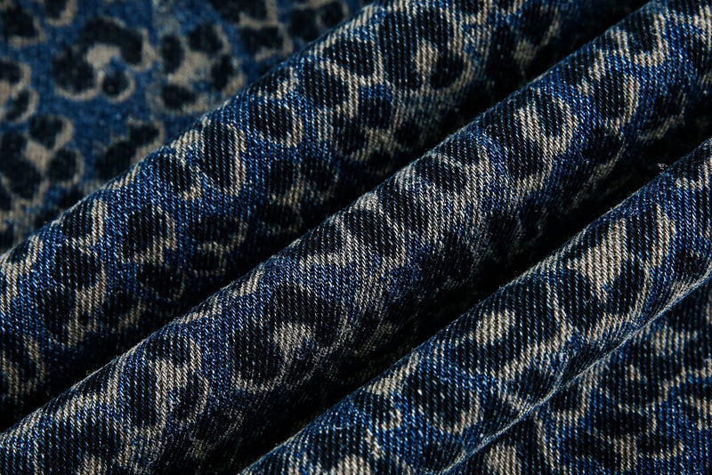 Close-up of blue leopard print denim fabric texture and folds