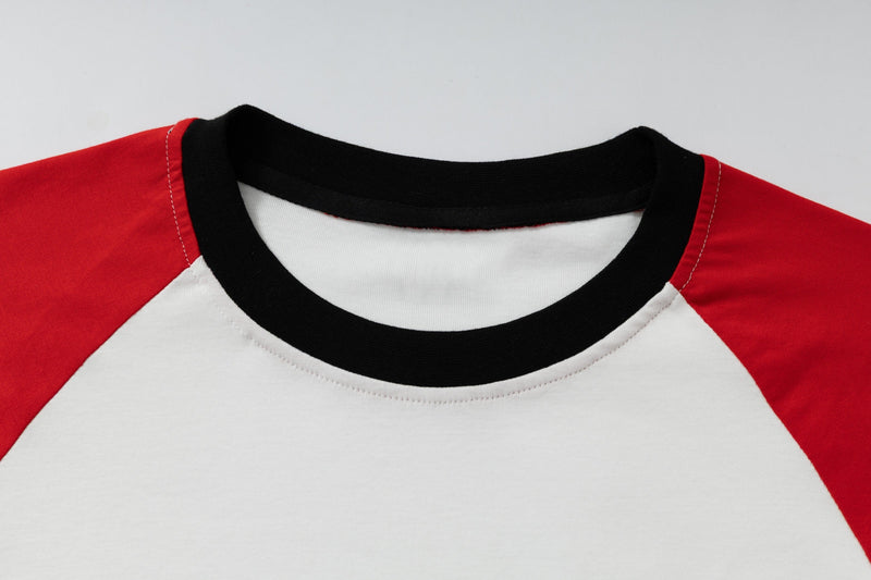 Close-up of black ribbed crew neck on red and white raglan long-sleeve T-shirt