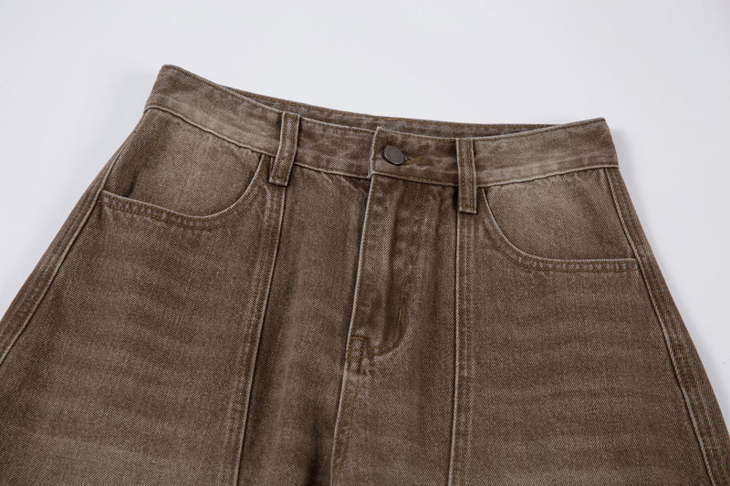 Close-up of the waistband on brown cargo pants with front button and belt loops