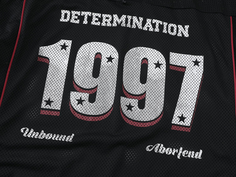 Close-up of front graphic on black mesh shirt showing DETERMINATION and 1997 print