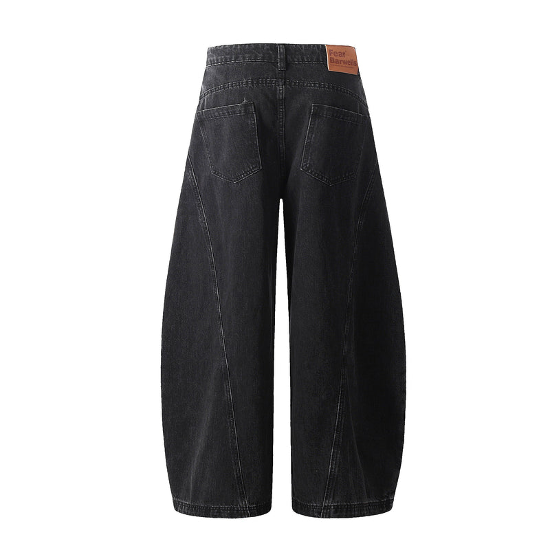 Back view of washed black wide-leg denim pants with patch pockets and logo label