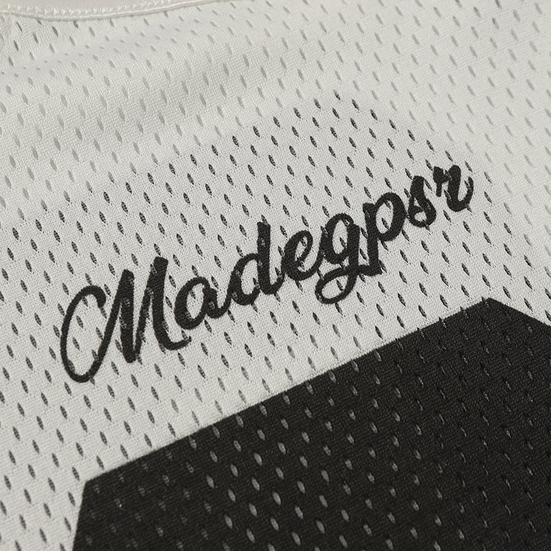 Close-up of a white mesh football jersey with black Madegpsr script and number 06 panel