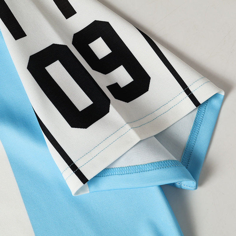 White and light blue football jersey with black number 09 and striped trim, close-up of hem and sleeve detail