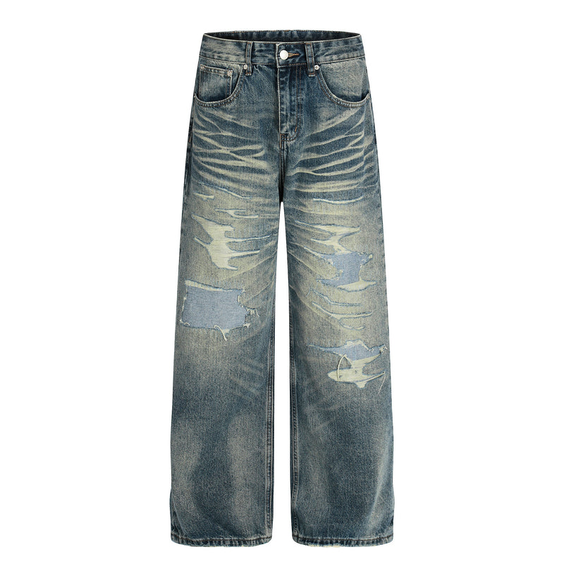 Front view of vintage washed wide-leg jeans with heavy distressing and fading