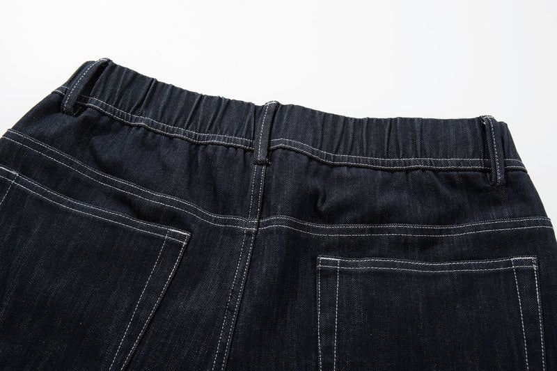 Close-up of the back waistband and belt loops on dark denim jeans