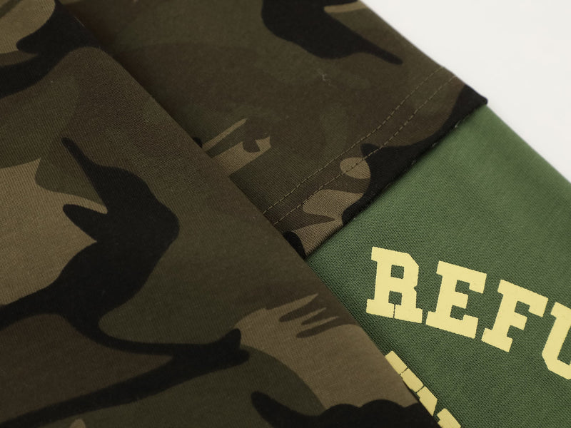 Close-up of olive camo seam where layered sleeve meets green underlayer