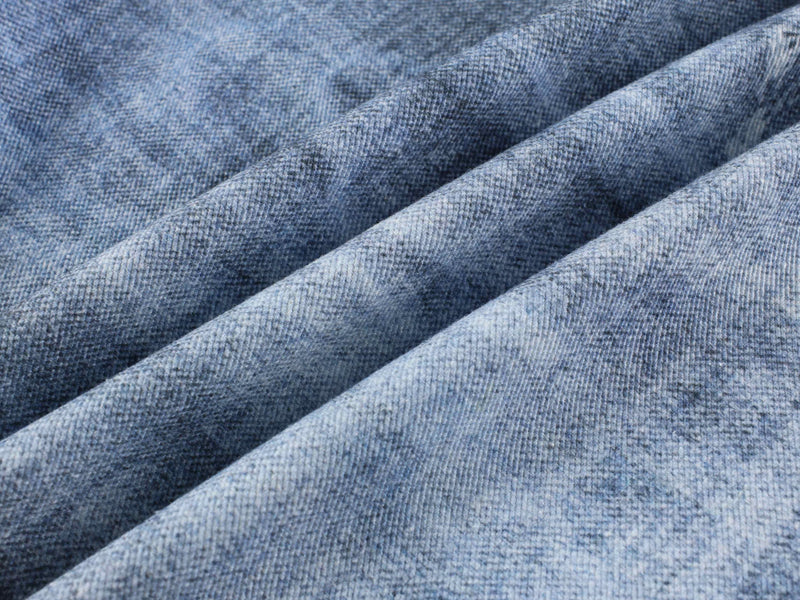 Close-up of blue denim fabric texture and wash pattern