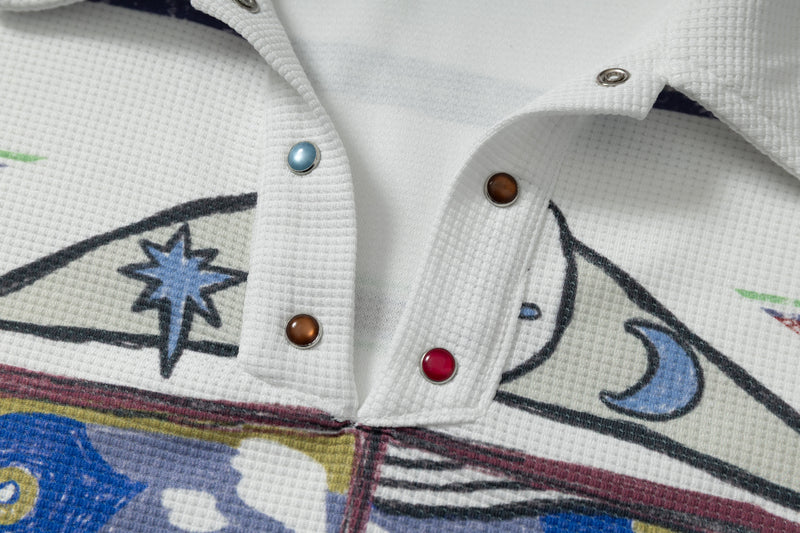 Close-up of snap button placket on white textured polo shirt with abstract graphic print