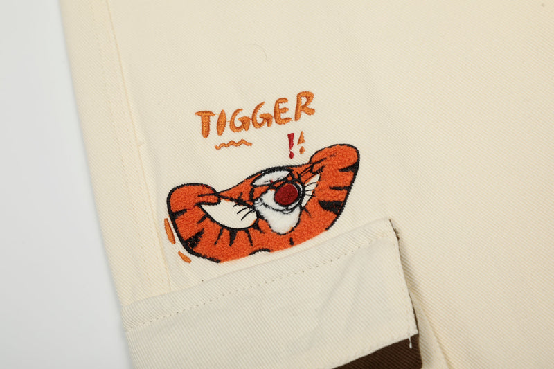 Close-up of Tigger patch on cream cargo pants side pocket
