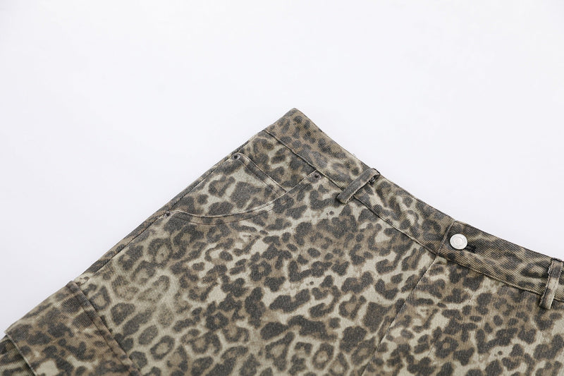 Close-up of front waistband on leopard print cargo shorts with button and belt loops